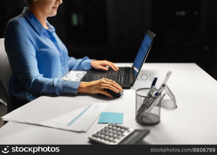 business, people and technology concept - close up of businesswoman using computer mouse for laptop. close up of businesswoman using computer mouse