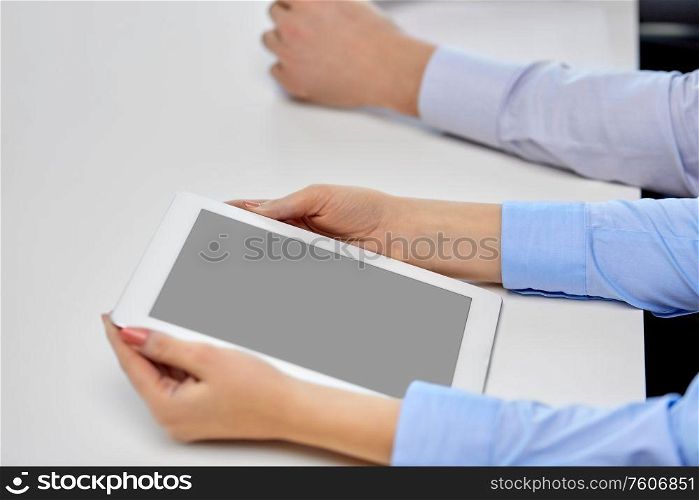 business, people and technology concept - close up of businesswoman with tablet pc at office. close up of businesswoman with tablet pc at office
