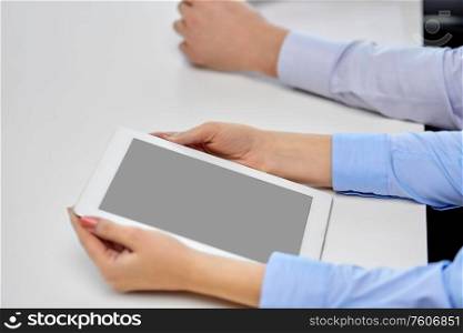 business, people and technology concept - close up of businesswoman with tablet pc at office. close up of businesswoman with tablet pc at office