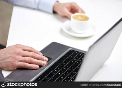 business, people and technology concept - close up of male hands with laptop and coffee cup at office. close up of male hands with laptop and coffee cup