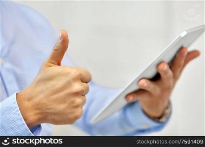 business, people and technology concept - close up of male hands with tablet pc computer showing thumbs up. close up of hands with tablet pc showing thumbs up