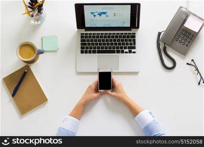 business, people and technology concept - hands of businesswoman with laptop computer and smartphone working at office. businesswoman with laptop and smartphone at office