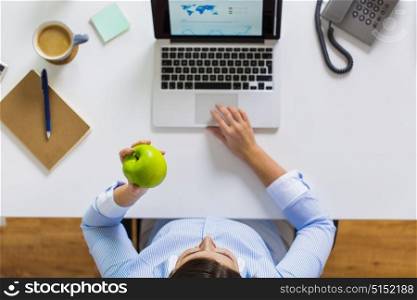 business, people and technology concept - hands of businesswoman with laptop computer and green apple working at office. businesswoman with apple and laptop at office