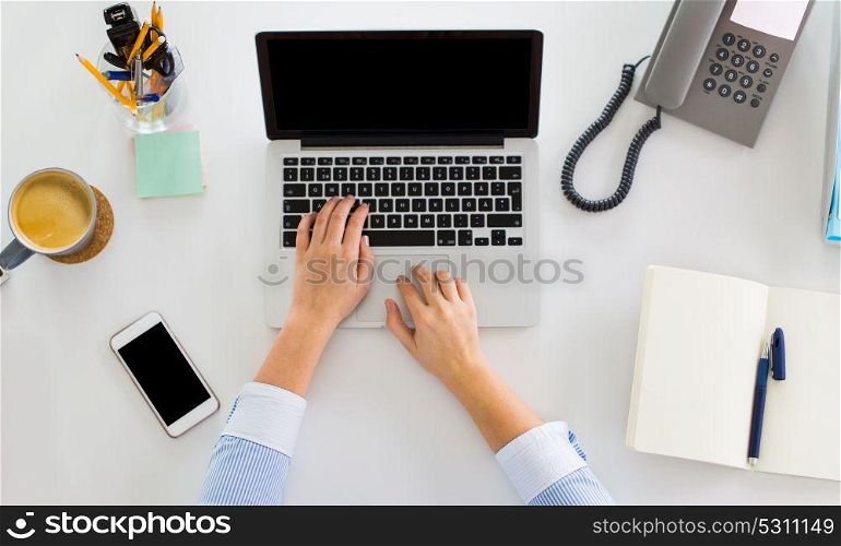 business, people and technology concept - hands of businesswoman with laptop computer working at office. hands of businesswoman working on laptop at office
