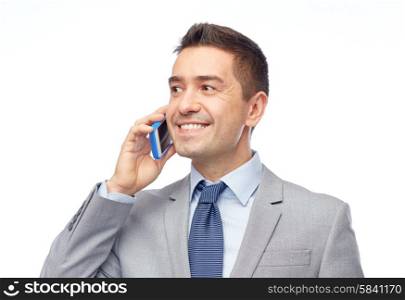 business, people and technology concept -happy businessman calling on smartphone