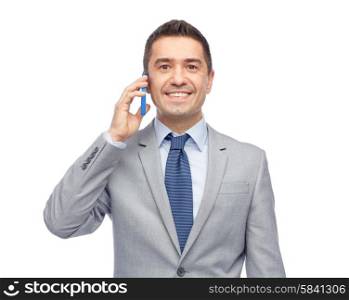 business, people and technology concept -happy businessman calling on smartphone