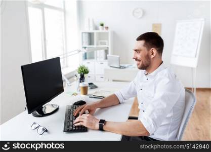 business, people and technology concept - happy businessman typing on computer keyboard at office. businessman typing on computer keyboard at office