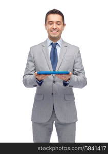 business, people and technology concept - happy smiling businessman in suit holding tablet pc computer