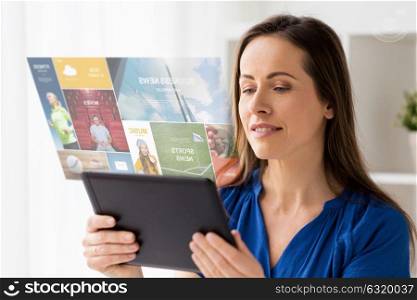 business, people and technology concept - happy smiling woman in glasses with tablet pc computer and virtual projection of web page at home or office. woman with tablet pc working at home or office