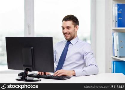 business, people and technology concept - happy young businessman with computer at office