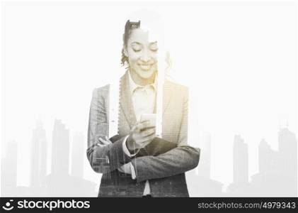 business, people and technology concept - smiling african american businesswoman looking at smartphone over city buildings and double exposure effect. smiling businesswoman looking at smartphone