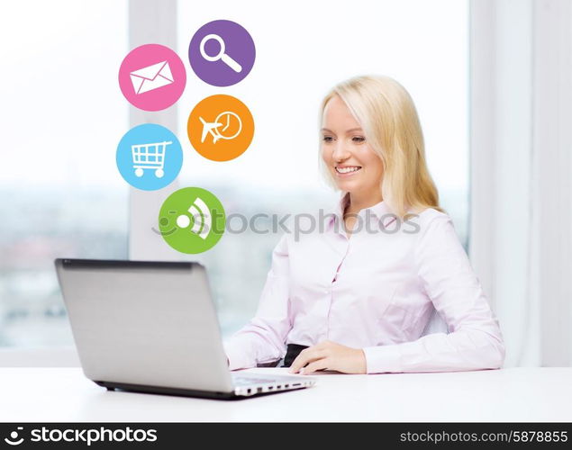 business, people and technology concept - smiling businesswoman or secretary with laptop computer and internet icons in office