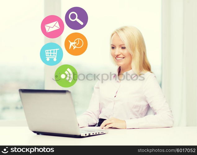 business, people and technology concept - smiling businesswoman or secretary with laptop computer and internet icons in office