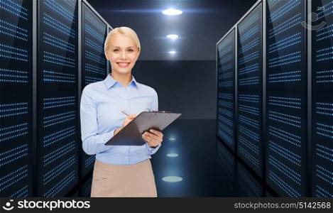 business, people and technology concept - smiling businesswoman with clipboard over server room background. businessman with clipboard over server room