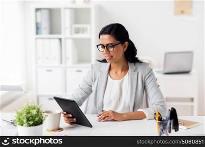 business, people and technology concept - smiling businesswoman with tablet pc computer at office. smiling businesswoman with tablet pc at office