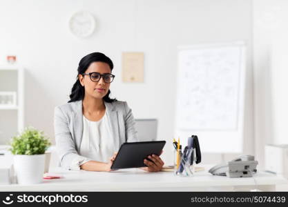 business, people and technology concept - smiling businesswoman with tablet pc computer at office. smiling businesswoman with tablet pc at office