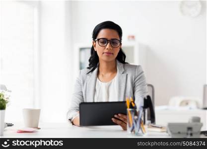 business, people and technology concept - smiling businesswoman with tablet pc computer at office. smiling businesswoman with tablet pc at office. smiling businesswoman with tablet pc at office