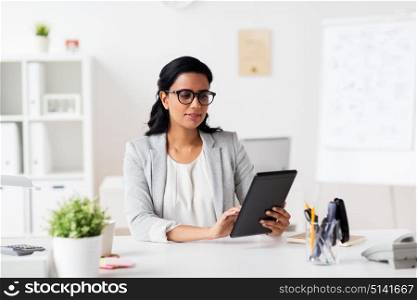 business, people and technology concept - smiling businesswoman with tablet pc computer at office. smiling businesswoman with tablet pc at office