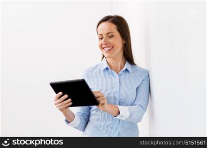 business, people and technology concept - smiling businesswoman with tablet pc computer at office. smiling businesswoman with tablet pc computer