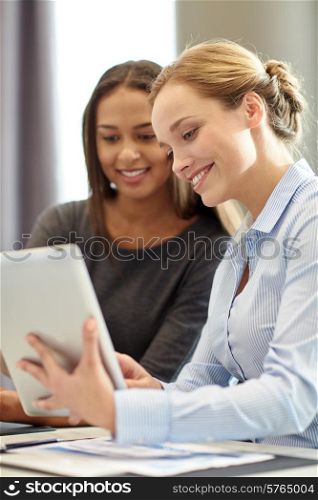 business, people and technology concept - smiling businesswomen with tablet pc computer meeting in office