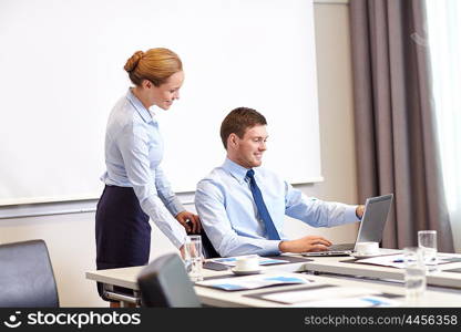 business, people and work concept - businessman and secretary with laptop working in office