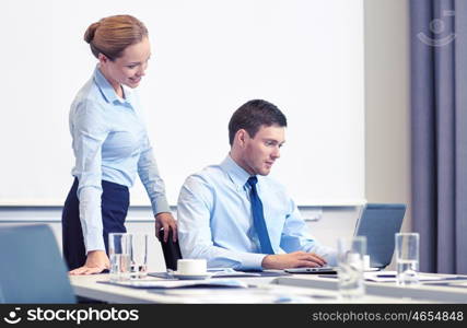 business, people and work concept - businessman and secretary with laptop working in office