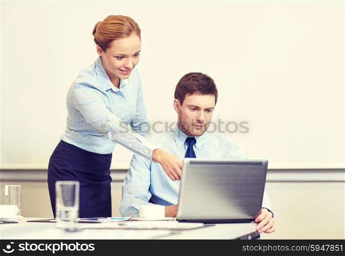 business, people and work concept - businessman and secretary with laptop working in office