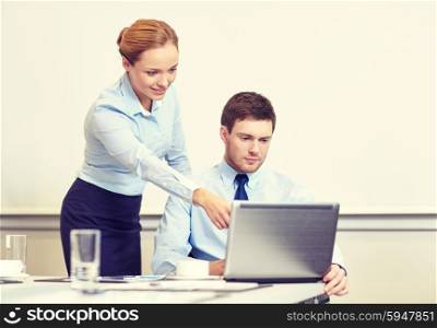 business, people and work concept - businessman and secretary with laptop working in office