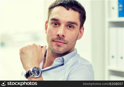 business, people and work concept - portrait of businessman in office