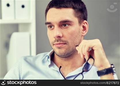 business, people and work concept - portrait of businessman with eyeglasses at office