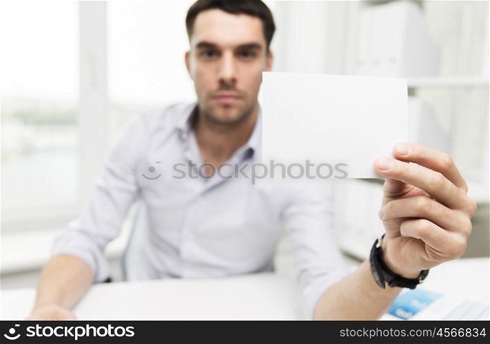business, people, announcement and advertisement concept - close up of businessman showing blank paper card at office