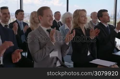 Business people applauding at meeting to speaker