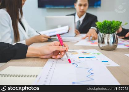 Business people are meeting and graphing business growth on a desk