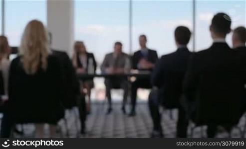Business people at conference, abstract defocused background