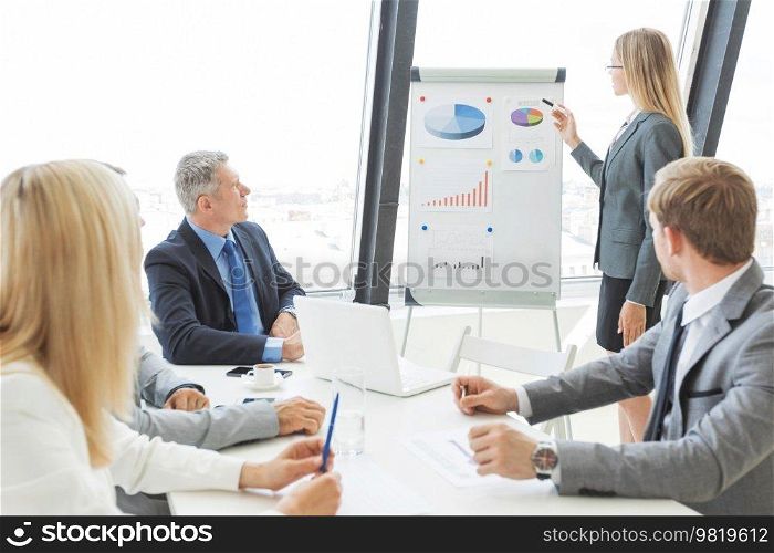 Business people at presentation in office. Businesswoman presenting financial reports on whiteboard.. Business people at presentation in office