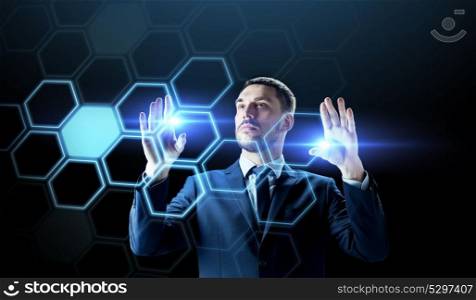 business, people, augmented reality and future technology concept - businessman working with virtual network hologram over black background. businessman working with virtual network hologram