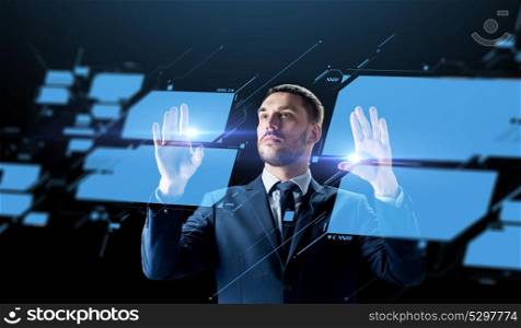 business, people, augmented reality and future technology concept - businessman working with virtual screen over black background. businessman working with virtual screen