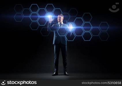 business, people, augmented reality and future technology concept - businessman working with virtual network hologram over black background. businessman working with virtual network hologram