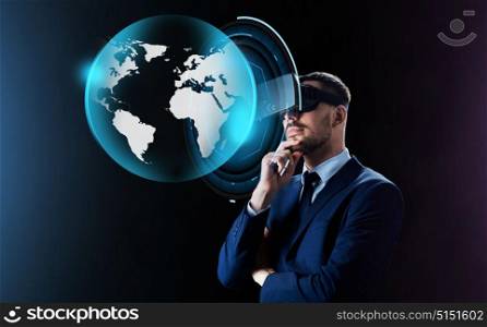 business, people, augmented reality and modern technology concept - businessman in virtual headset looking at earth projection over black background. businessman in virtual reality headset over black
