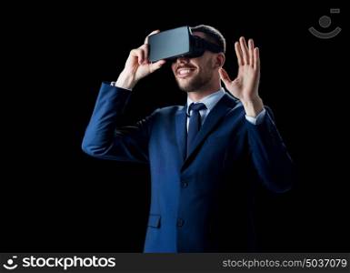 business, people, augmented reality and modern technology concept - smiling businessman in virtual headset over black background. businessman in virtual reality headset over black