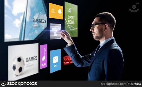 business, people, augmented reality and multimedia concept - businessman with applications on virtual screen over black background. businessman with applications on virtual screen