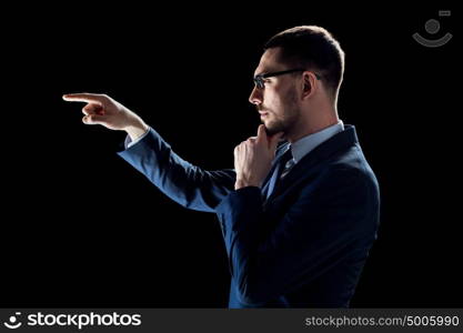 business, people, augmented reality and office concept - businessman in suit over black background. businessman in suit over black