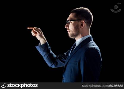 business, people, augmented reality and office concept - businessman in suit over black background. businessman in suit over black