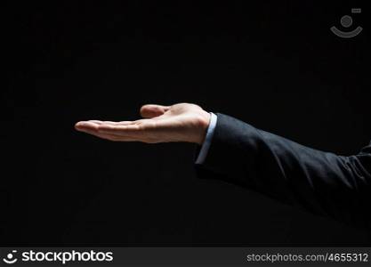 business, people, bankruptcy and advertisement concept - close up of businessman with empty hand over black