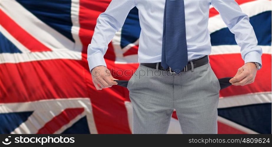 business, people, bankruptcy and failure concept - close up of businessman showing empty pockets over british flag background