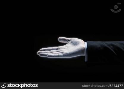 business, people, bankruptcy and retirement concept - close up of glowing empty businessman hand over black background. glowing businessman hand over black background