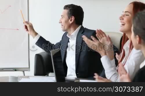 Business people clapping hands for consultant after a presentation in the office