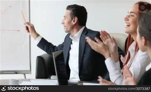 Business people clapping hands for consultant after a presentation in the office