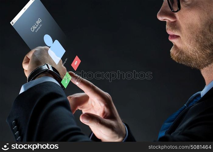 business, people, communication and modern technology concept - close up of businessman with smartwatch and incoming call virtual projection over black background. close up of businessman with smartwatch