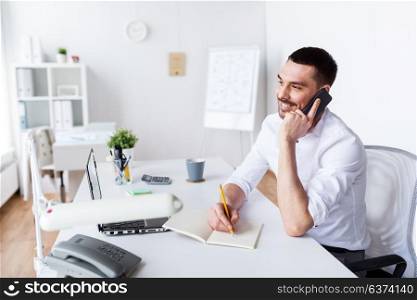 business, people, communication and technology concept - businessman calling on smartphone and writing to notebook at office. businessman calling on smartphone at office